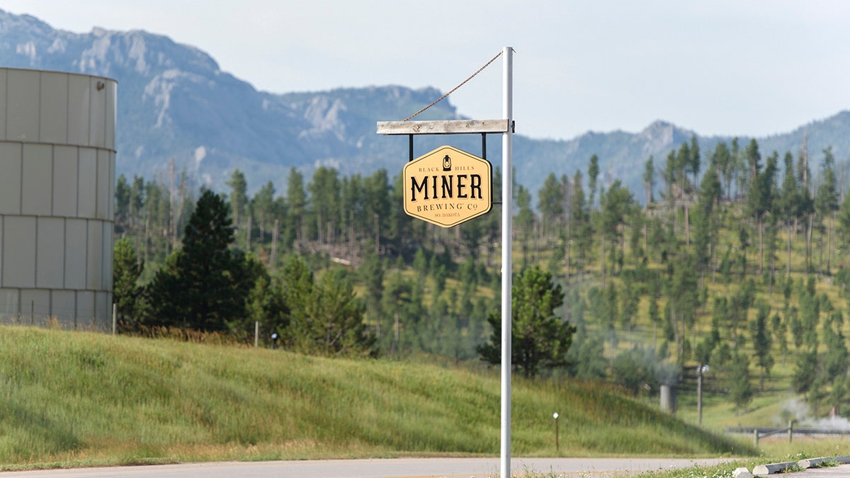 Miner Brewing sign and mountains