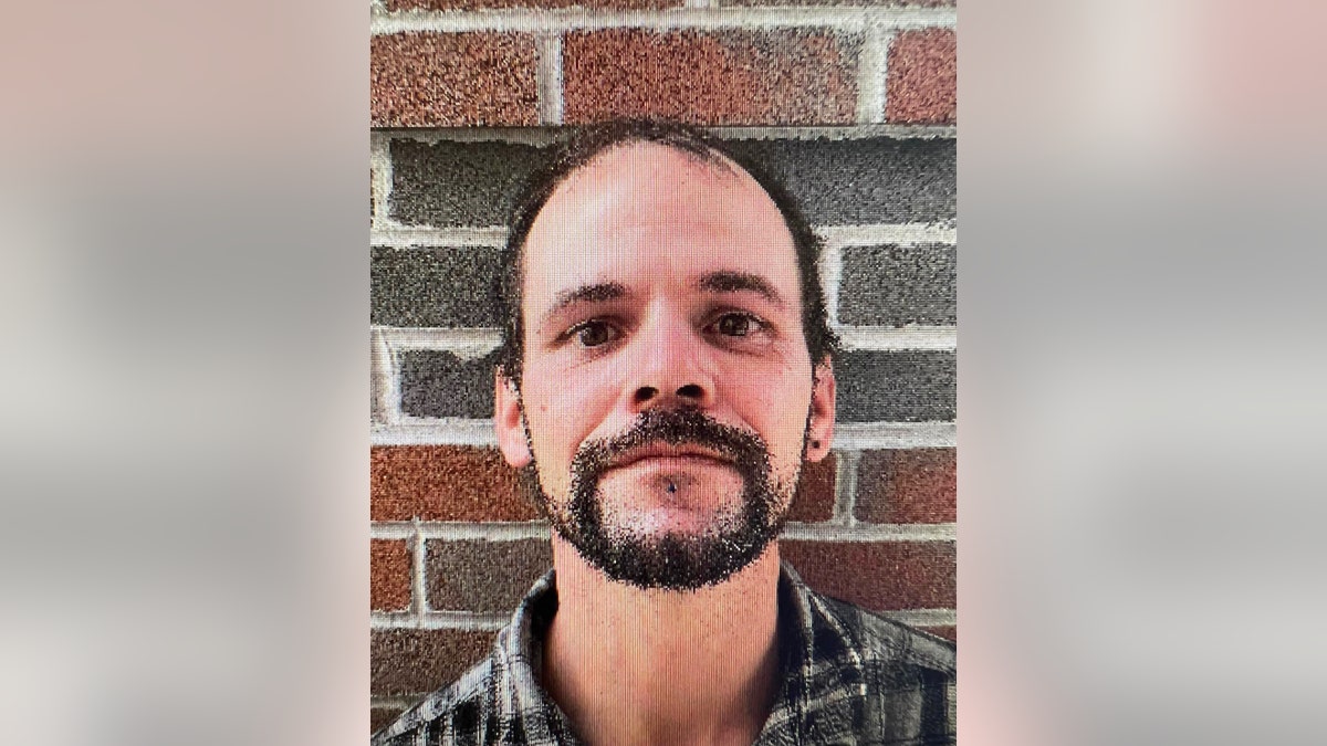 Nicholas Hansen poses in front of a brick wall