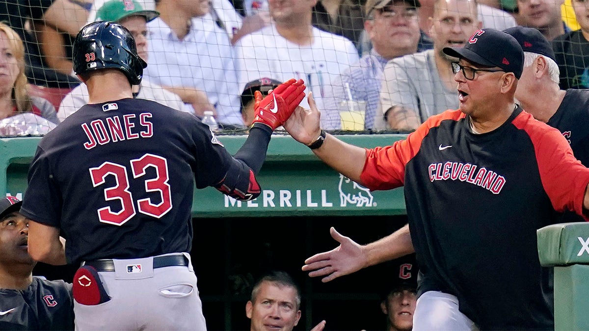 Nolan Jones is congratulated by Terry Francona