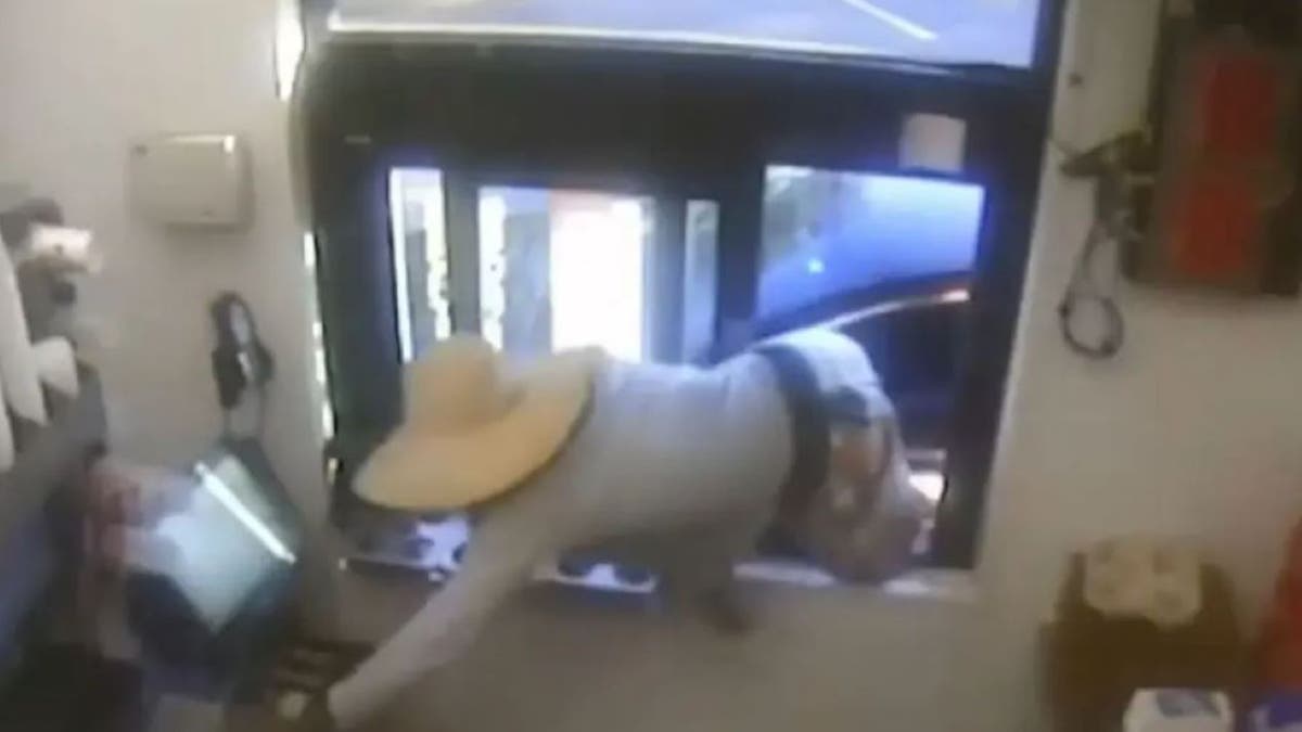 Screenshot of man robbing Wendy's drive-thru