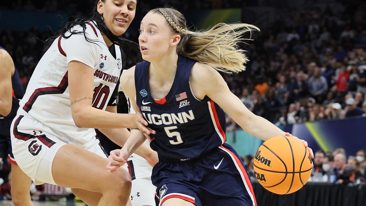 Paige Bueckers drives past a defender