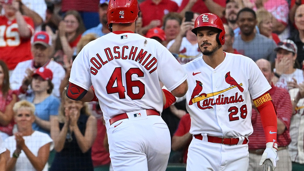 Nolan Arenado high-fives Paul Goldschmidt