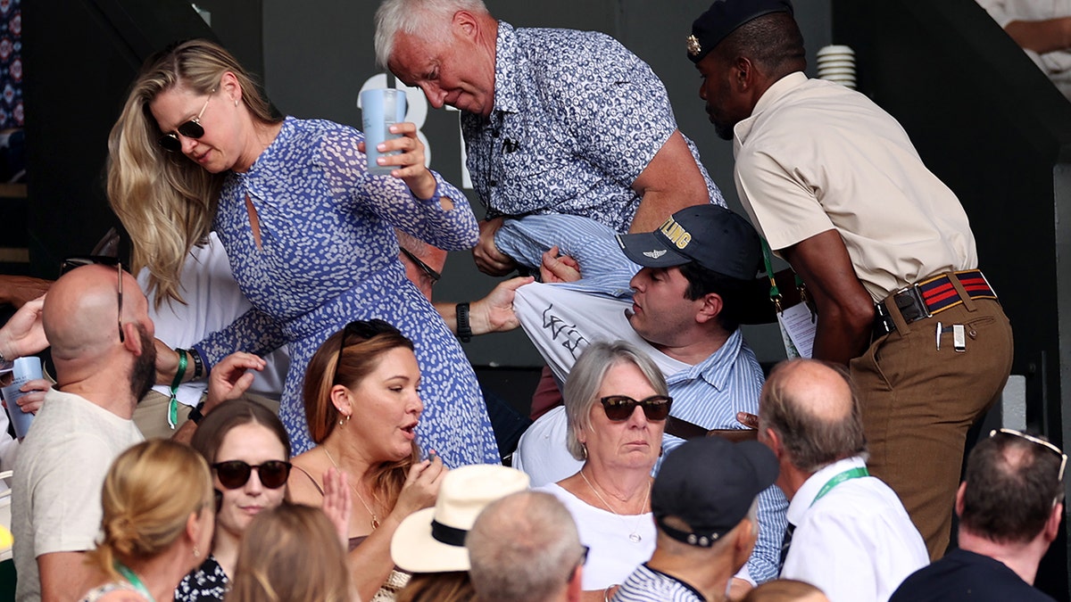 A protester tackled during Wimbledon