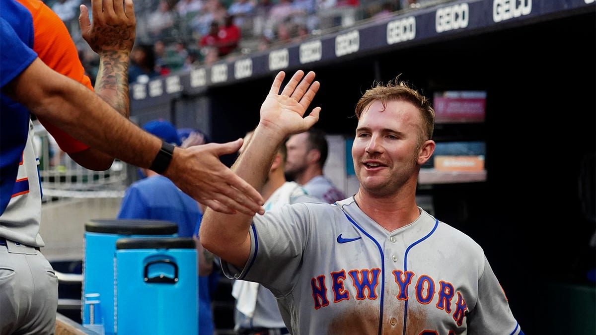 Pete Alonso high-fives teammates
