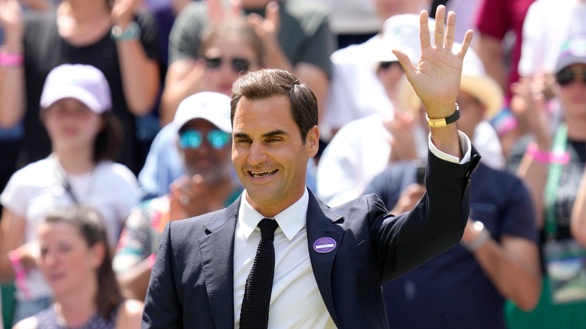 Roger Federer waves to the crowd