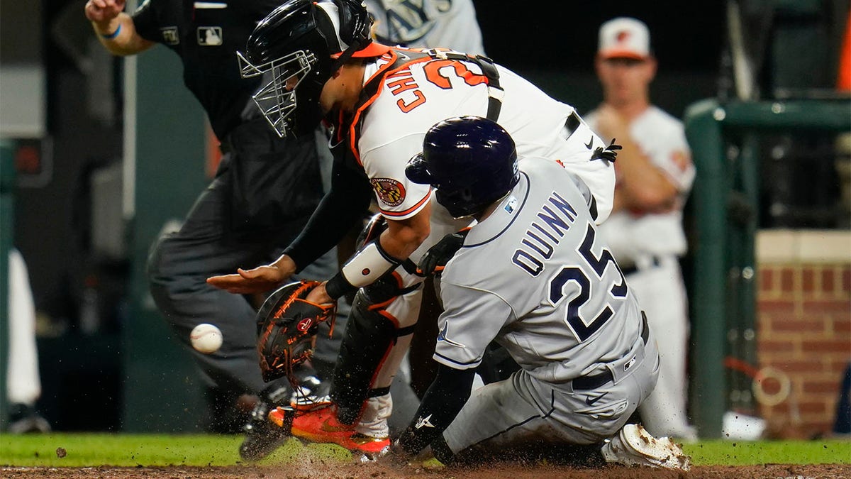 Roman Quinn slides into home plate