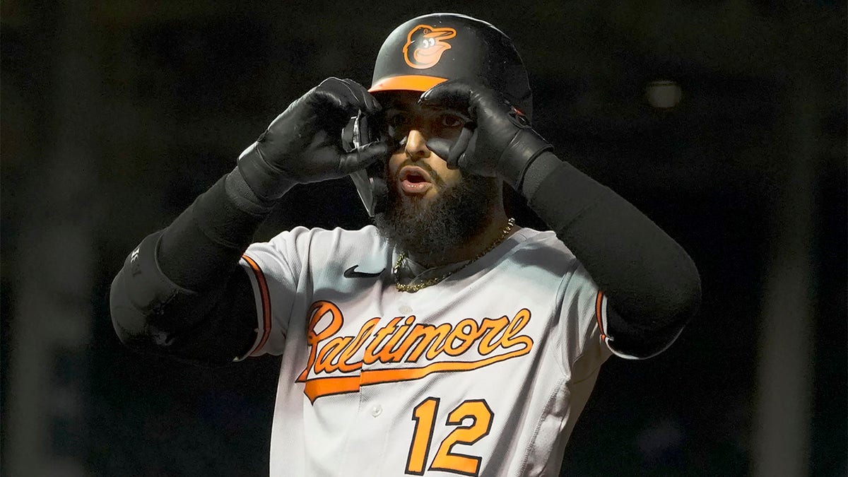 Rougned Odor gestures to teammates in dugout