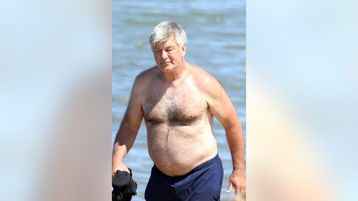 Alec Baldwin carried his shirt by his side at the beach
