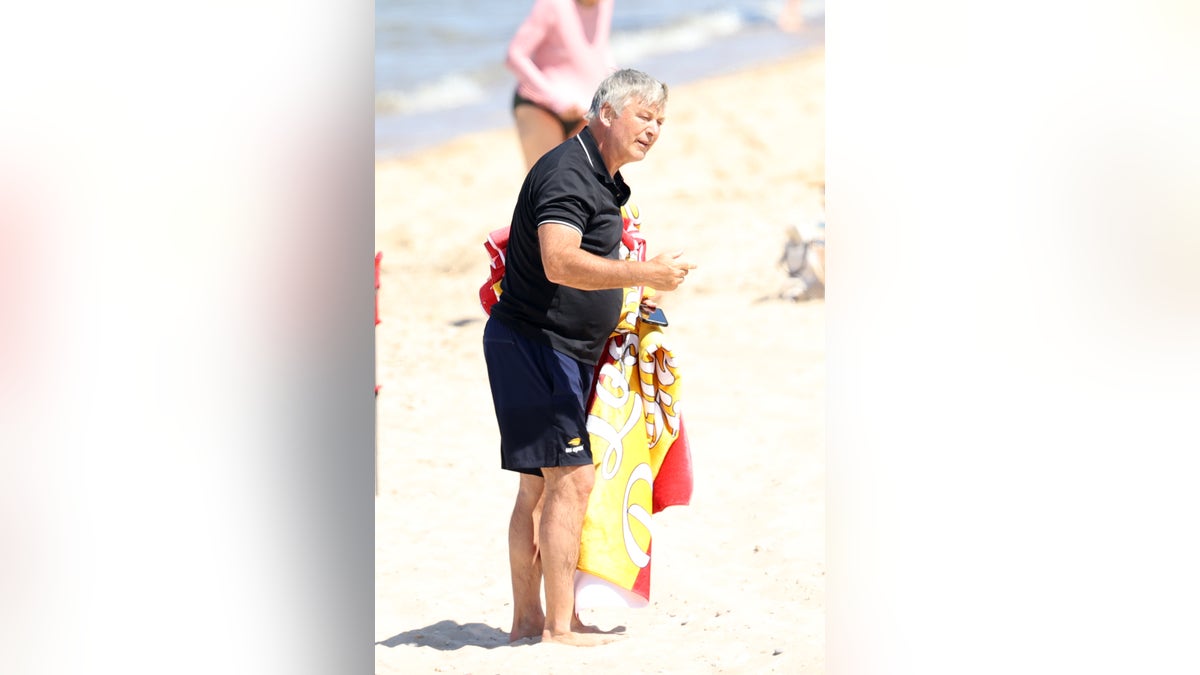 Alec Baldwin covered up while leaving the beach