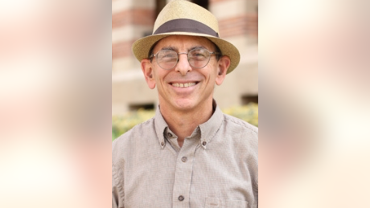 Photo showing recently-retired anthropology professor Joseph Manson smiling