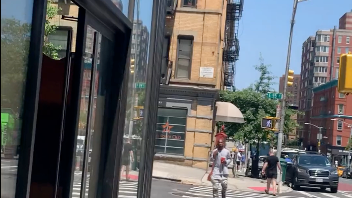 The man is walking in a crosswalk
