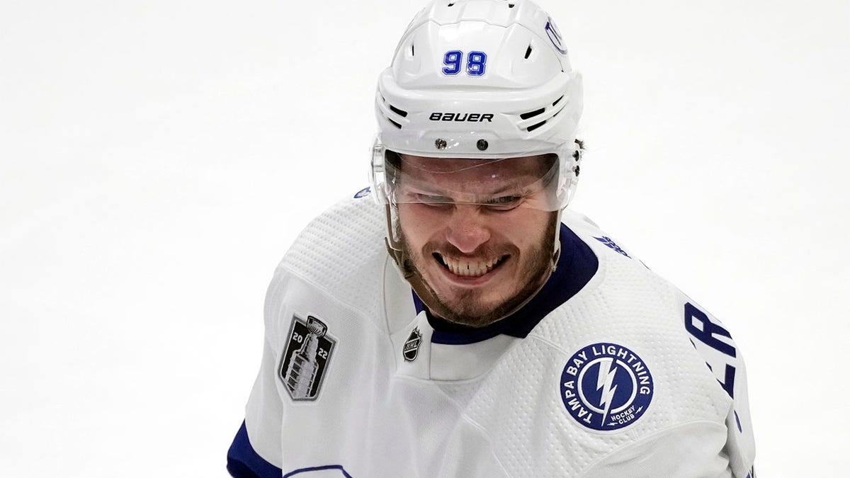 Mikhail Sergachev smiles on the ice