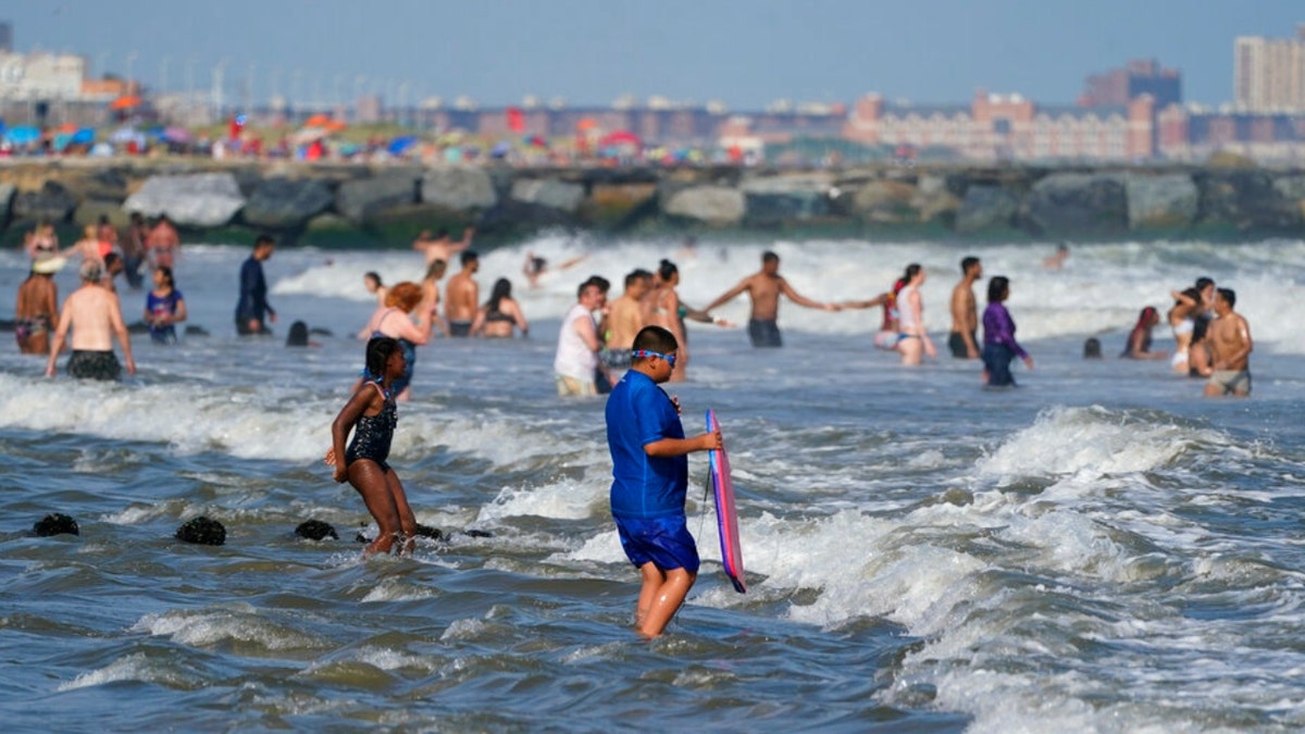 People in the water at Rockaway Beach