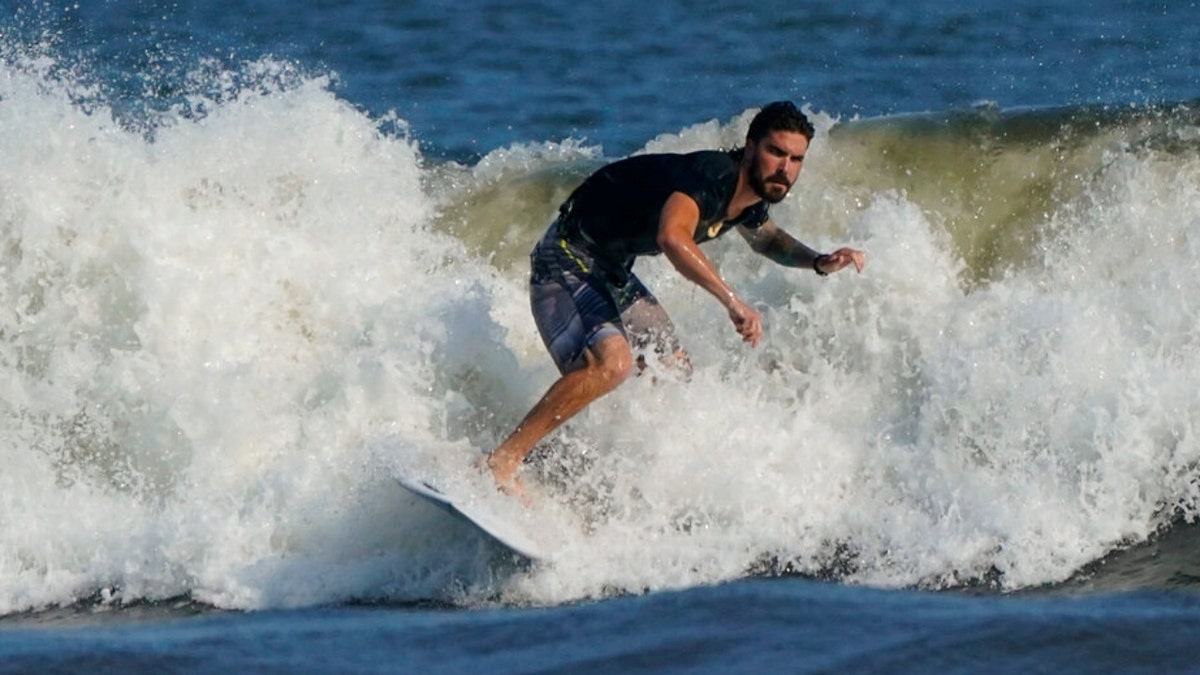 A surfer at Rockaway Beach