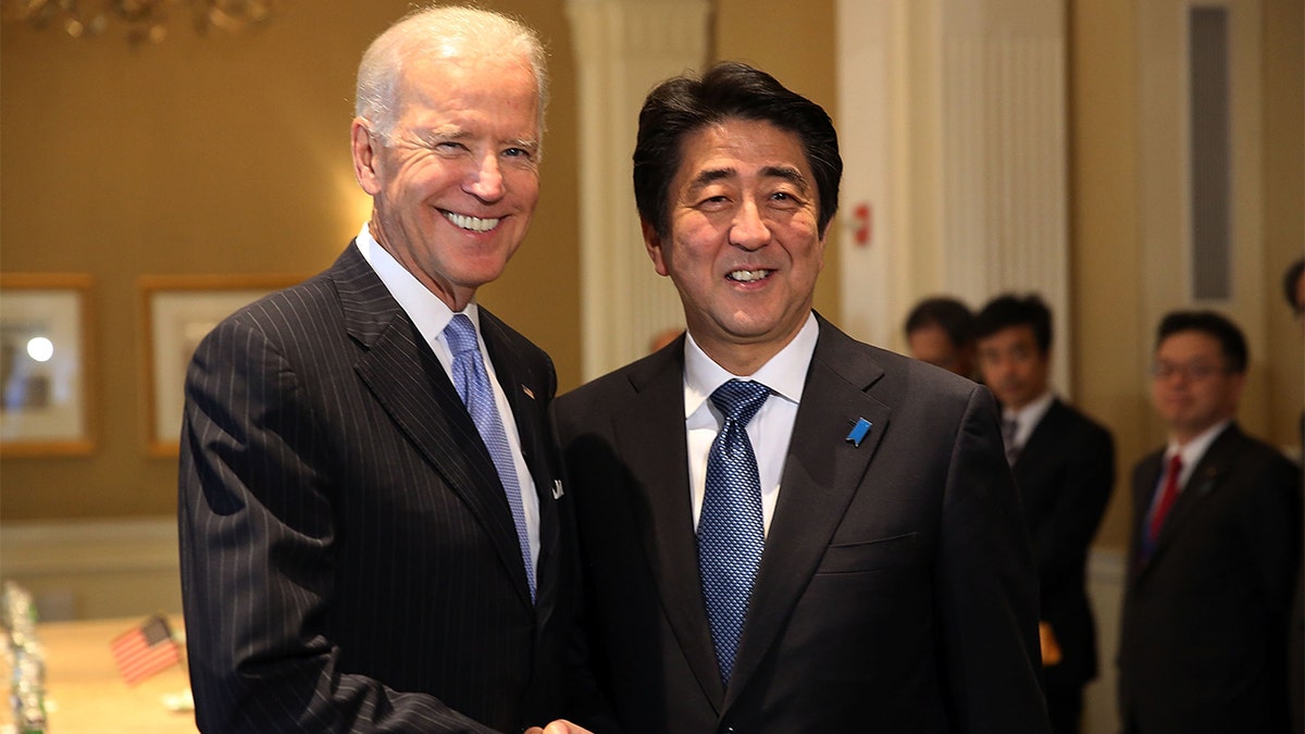 Joe Biden shakes hands with Shinzo Abe in 2014