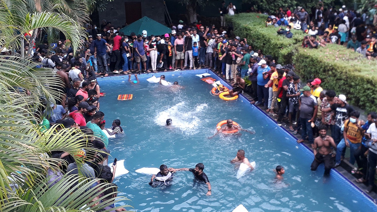 Sri Lanka protesters who stormed the president's residence swim in a pool