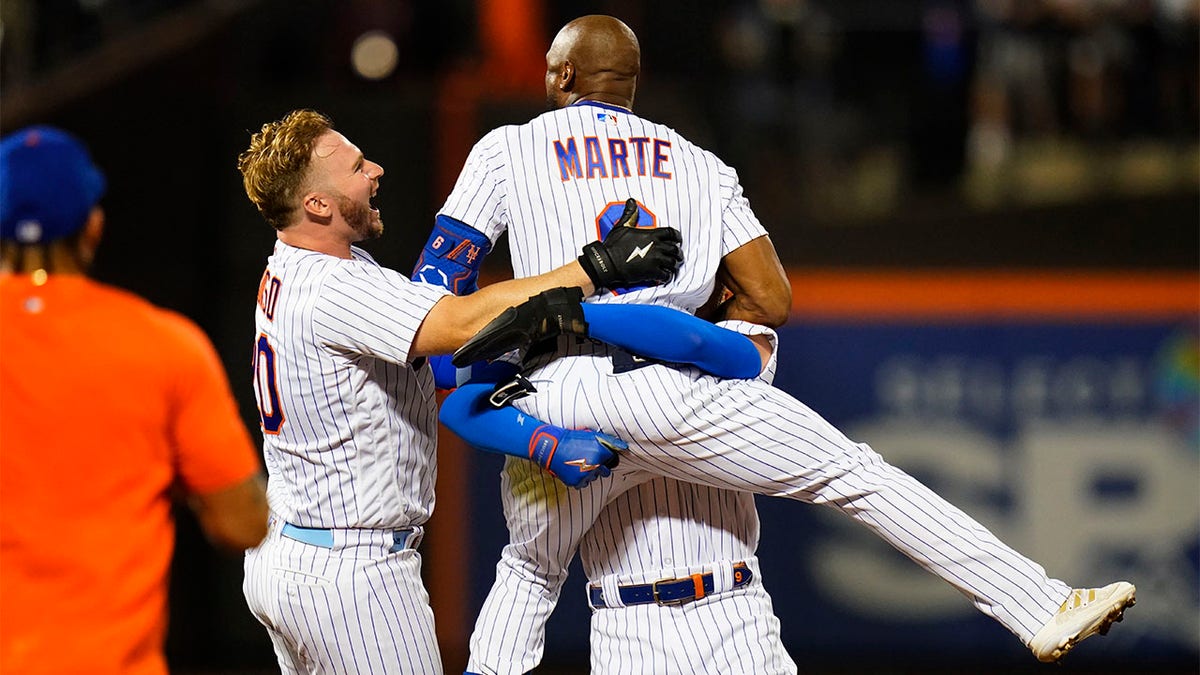 Pete Alonso runs to Starling Marte in celebration