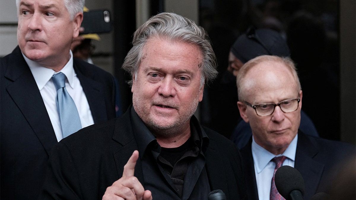 Steve Bannon and legal team speak with the media outside federal court