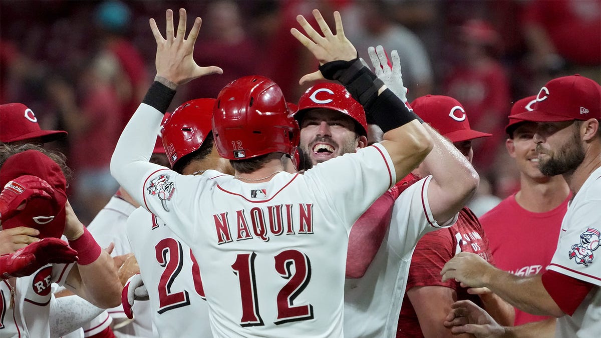 Tyler Naquin and Mike Moustakas celebrate