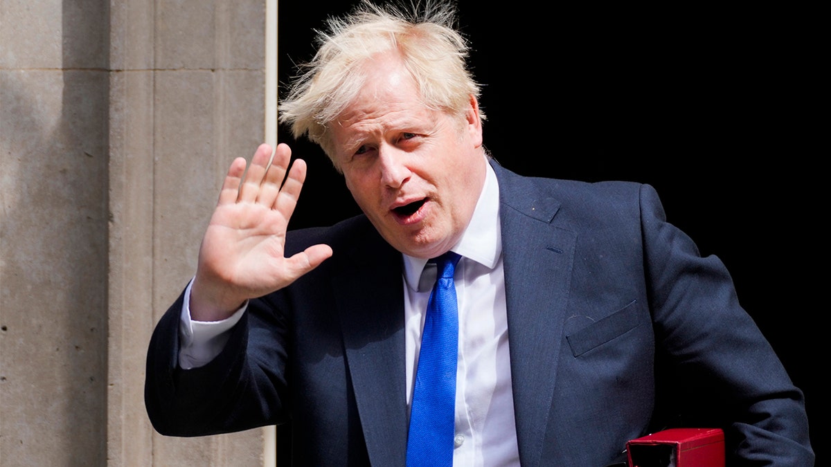 UK Prime Minister Boris Johnson waves to reporters July 6, 2022 in London