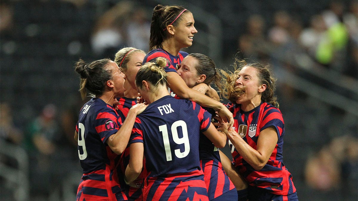 Alex Morgan is congratulated after scoring goal