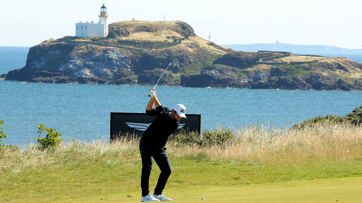 Viktor Hovland swings in front of a lighthouse