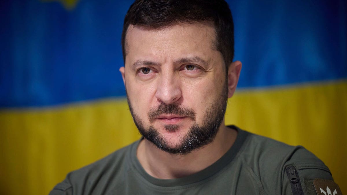 Volodymyr Zelensky behind Ukraine flag