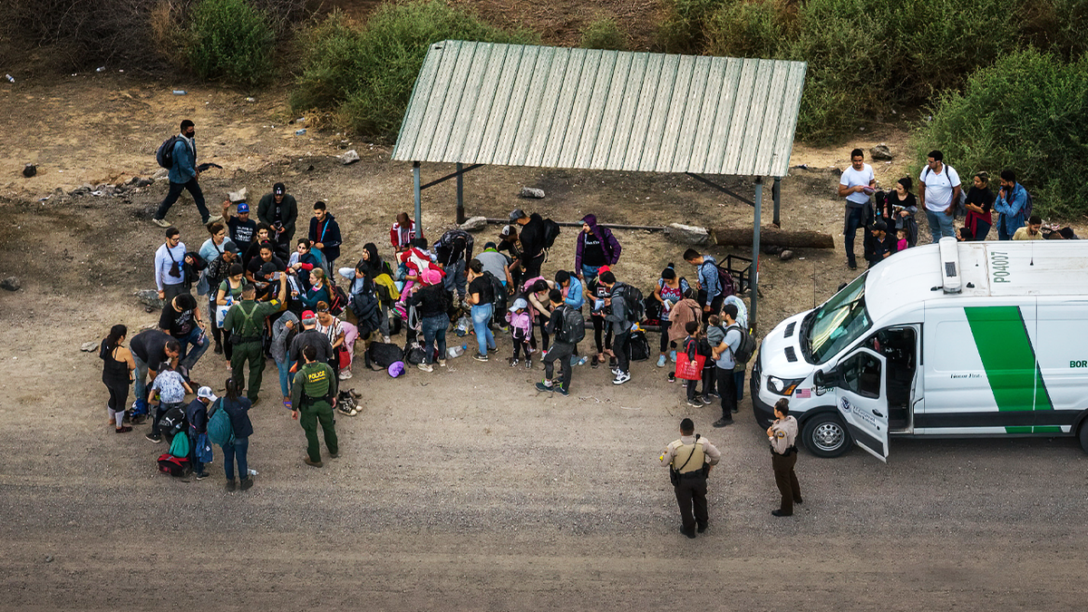 Illegal immigrants at the border waiting to be picked up by Border Patrol