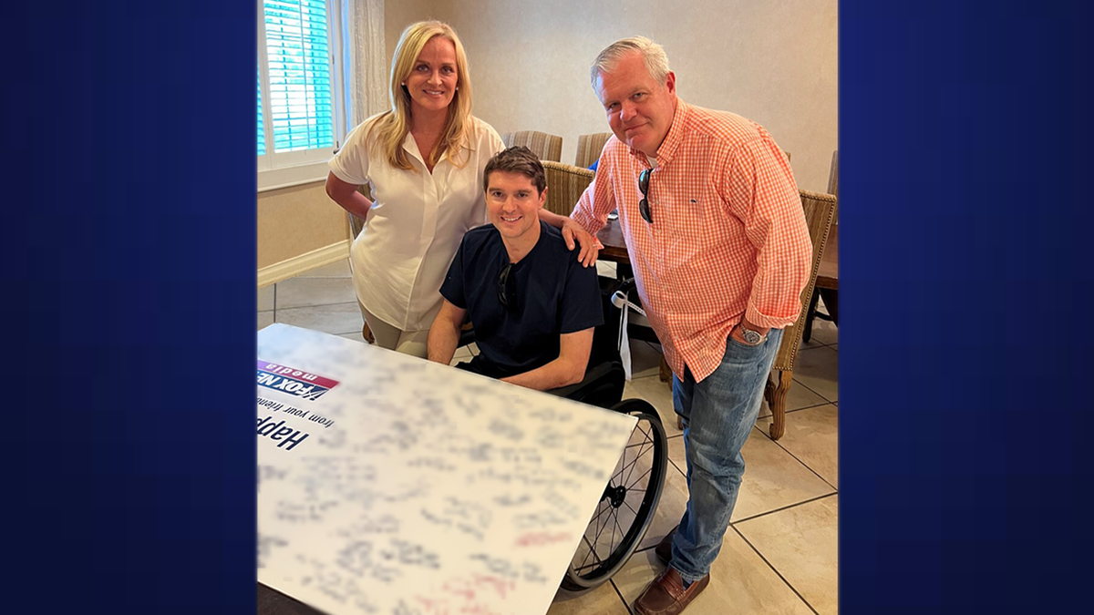 Suzanne Scott and Jay Wallace with Benjamin Hall at hospital