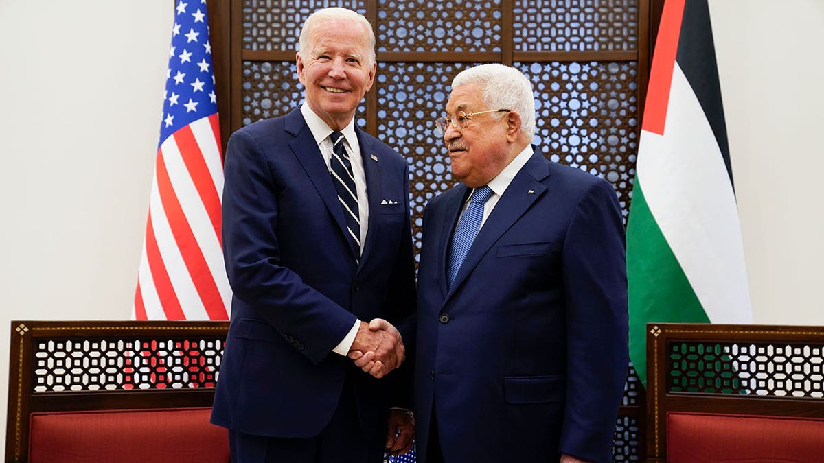 Palestinian President Mahmoud Abbas and U.S. President Joe Biden shake hands in the West Bank town of Bethlehem, Friday, July 15, 2022.