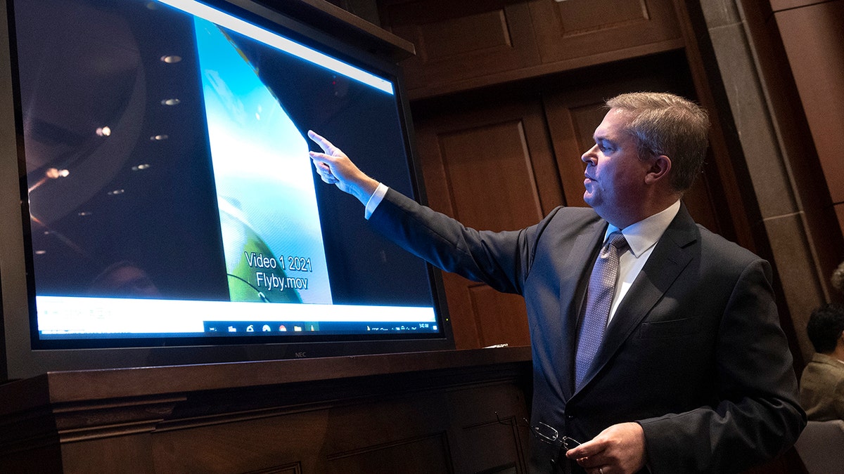 U.S. Deputy Director of Naval Intelligence Scott Bray explains a video of an unidentified aerial phenomen