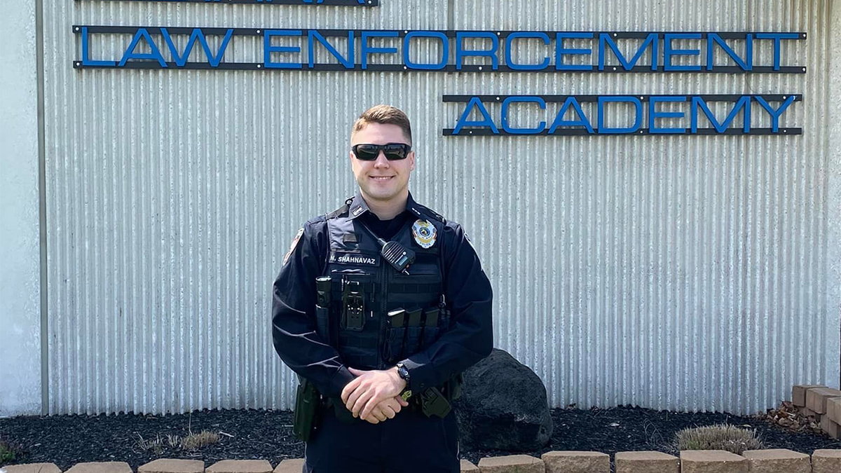 Elwood Police Officer Noah Shahnavaz smiles in uniform wearing sunglasses