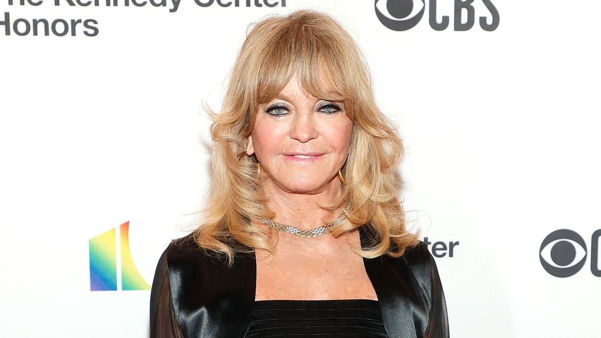 Goldie Hawn shimmers in black silk dress.