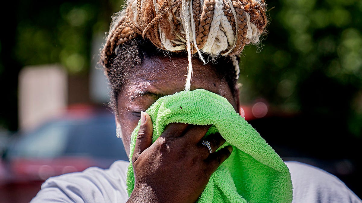 Washington woman wiping face in heat wave