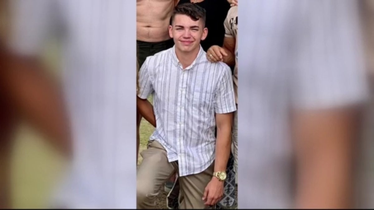 Deceased 18-year-old Jacob Hills of Grand Blanc, Michigan, in a striped white shirt and khakis