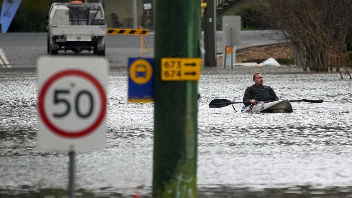 Man in kayak during Sydney flooding