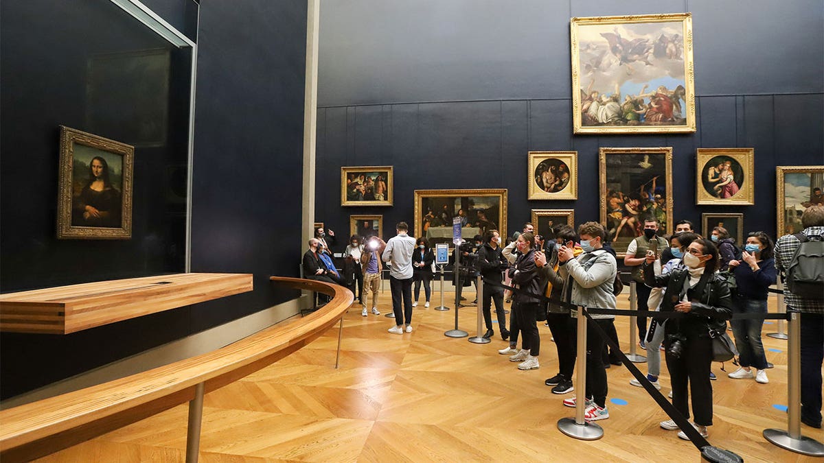 People lining up to get a picture of the Mona Lisa