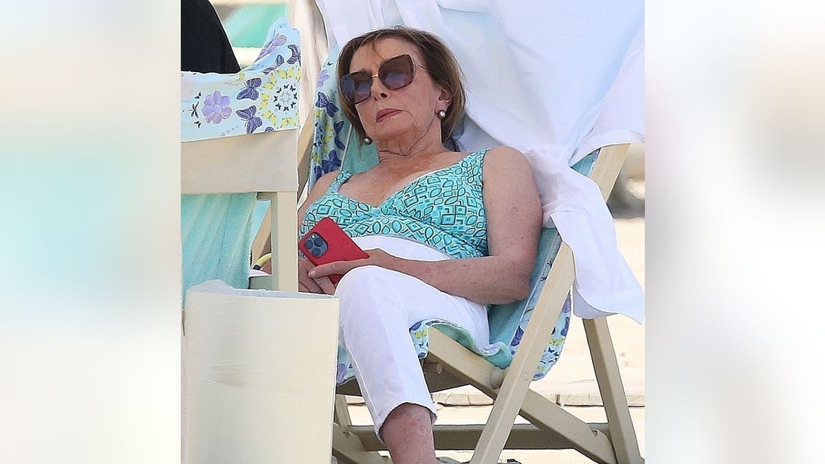 Nancy Pelosi rests on a beach in Italy