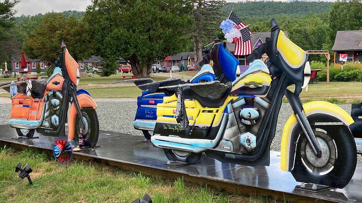 colorful motorcycles with American flags lined up outside 