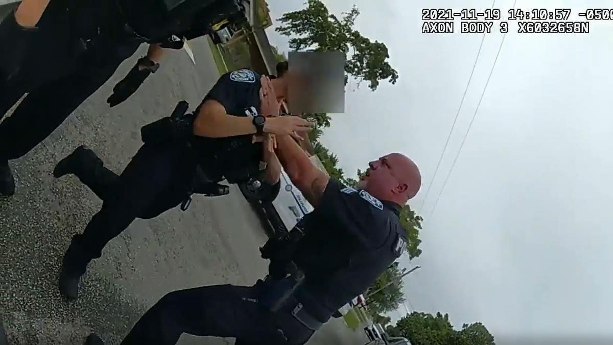 Christopher Pullease with hands on officer's neck