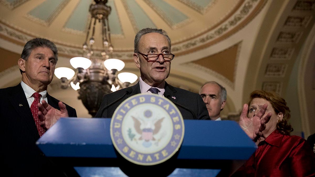 Chuck Schumer, Joe Manchin and others in Washington, D.C.