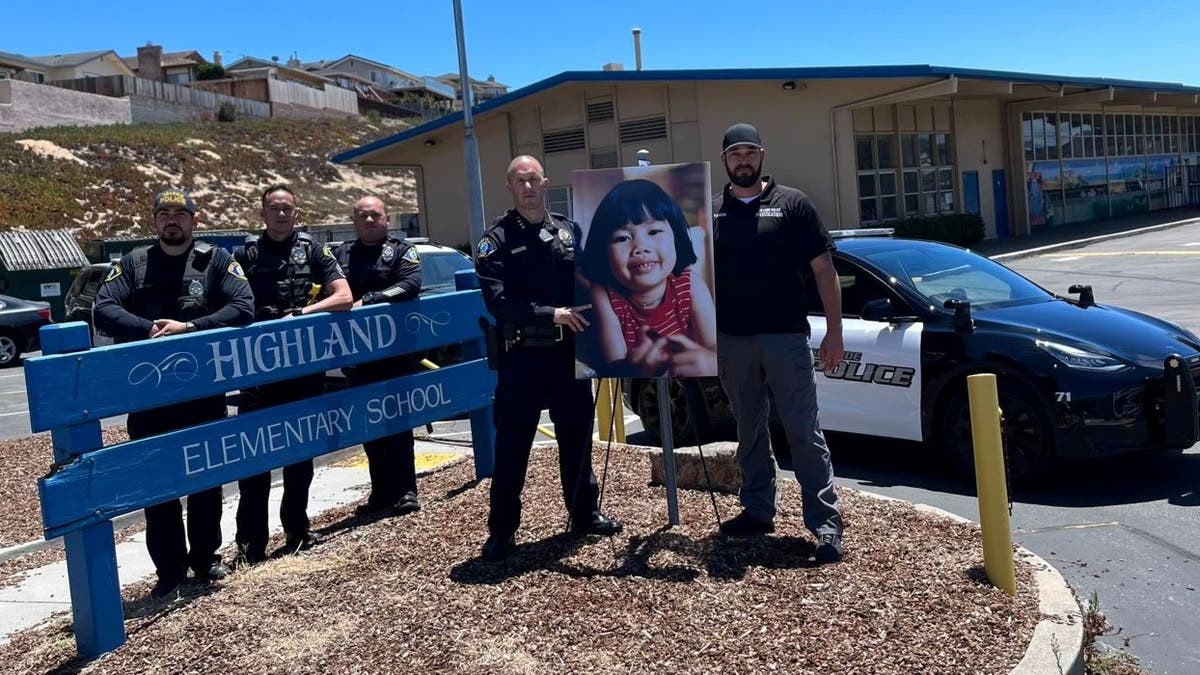 Seaside police officers with photo of Anne Pham