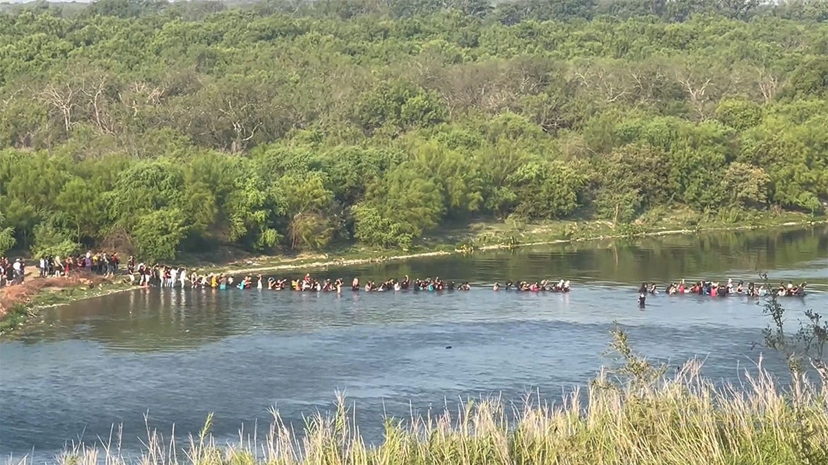 Migrants crossing Texas border by river