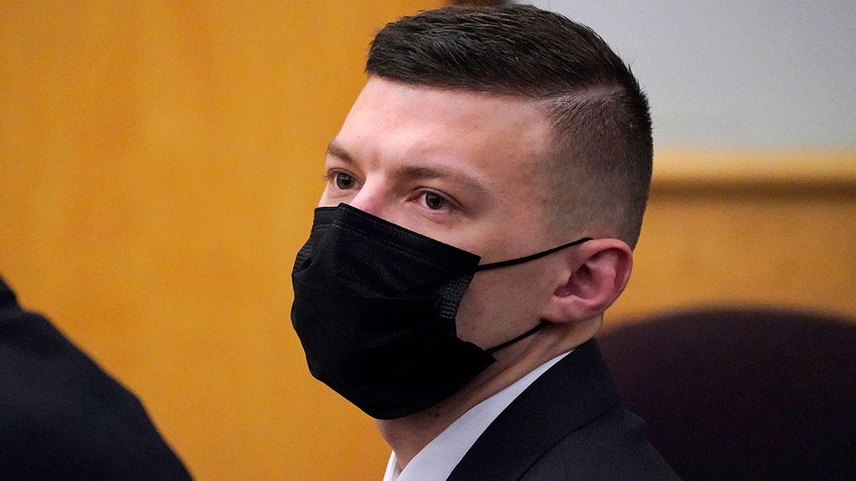 Volodymyr Zhukovskyy with a black mask and suit in court