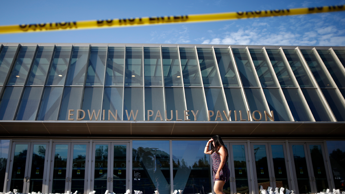 Photo of woman walking in front of UCLA's Pauley Pavilion