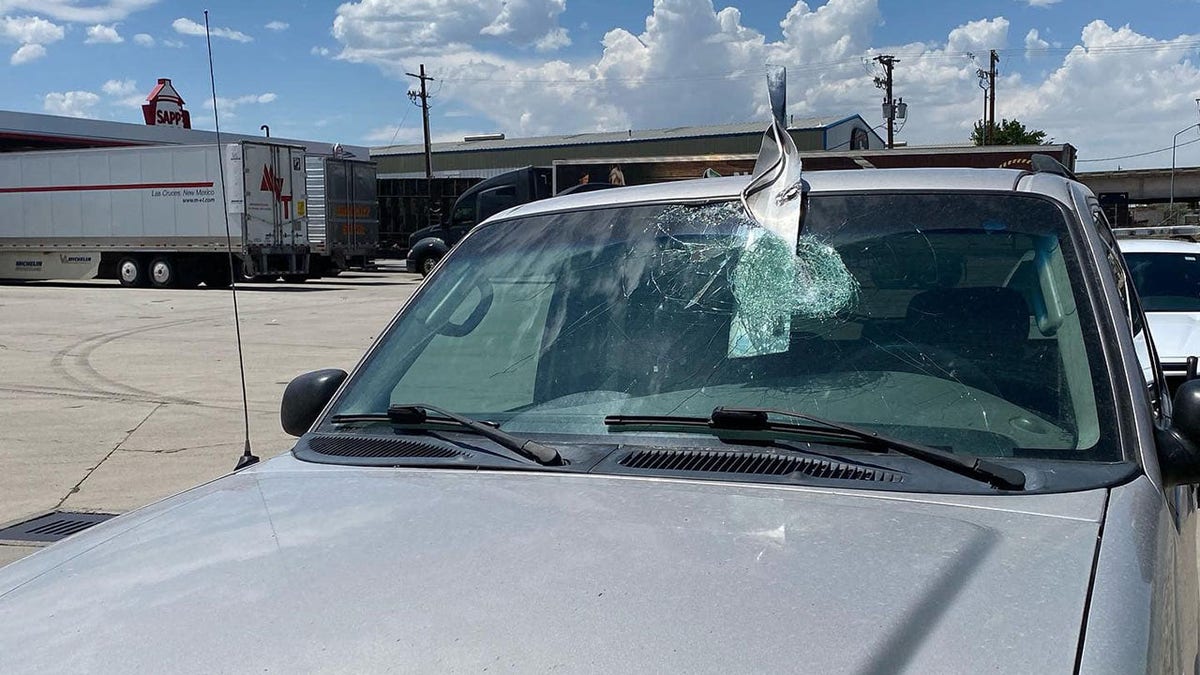 Windshield pierced by metal debris