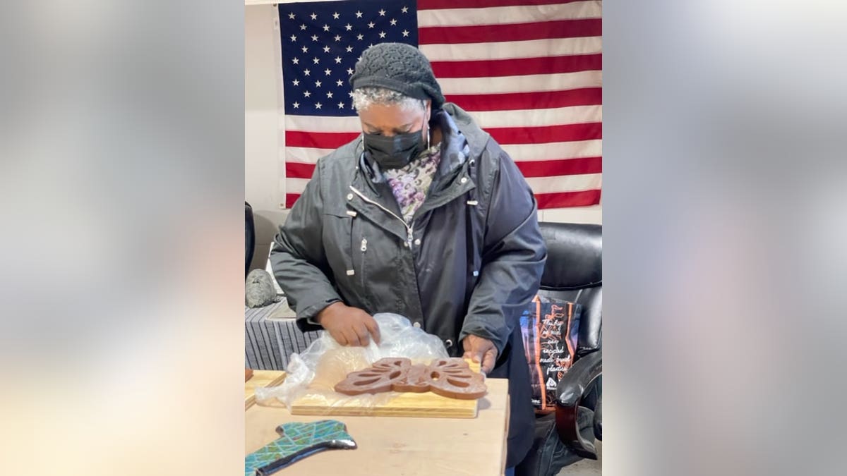 women making art by American flag