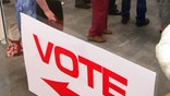 FILE - Voters stand in line waiting for ballot for the North Carolina primary at a library in Raleigh, N.C., on May 6, 2008. Tens of thousands of people serving punishments for felony convictions in North Carolina but who aren’t behind bars can now register to vote and cast ballots following an appeals court ruling. Expanding the scope of those able to register and vote began on Wednesday, July 27, 2022, the State Board of Elections said. (AP Photo/Jim R. Bounds, File)
