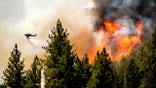 Helicopter dumping fire retardant