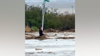 Arizona woman clinging to stop sign rescued from floodwaters